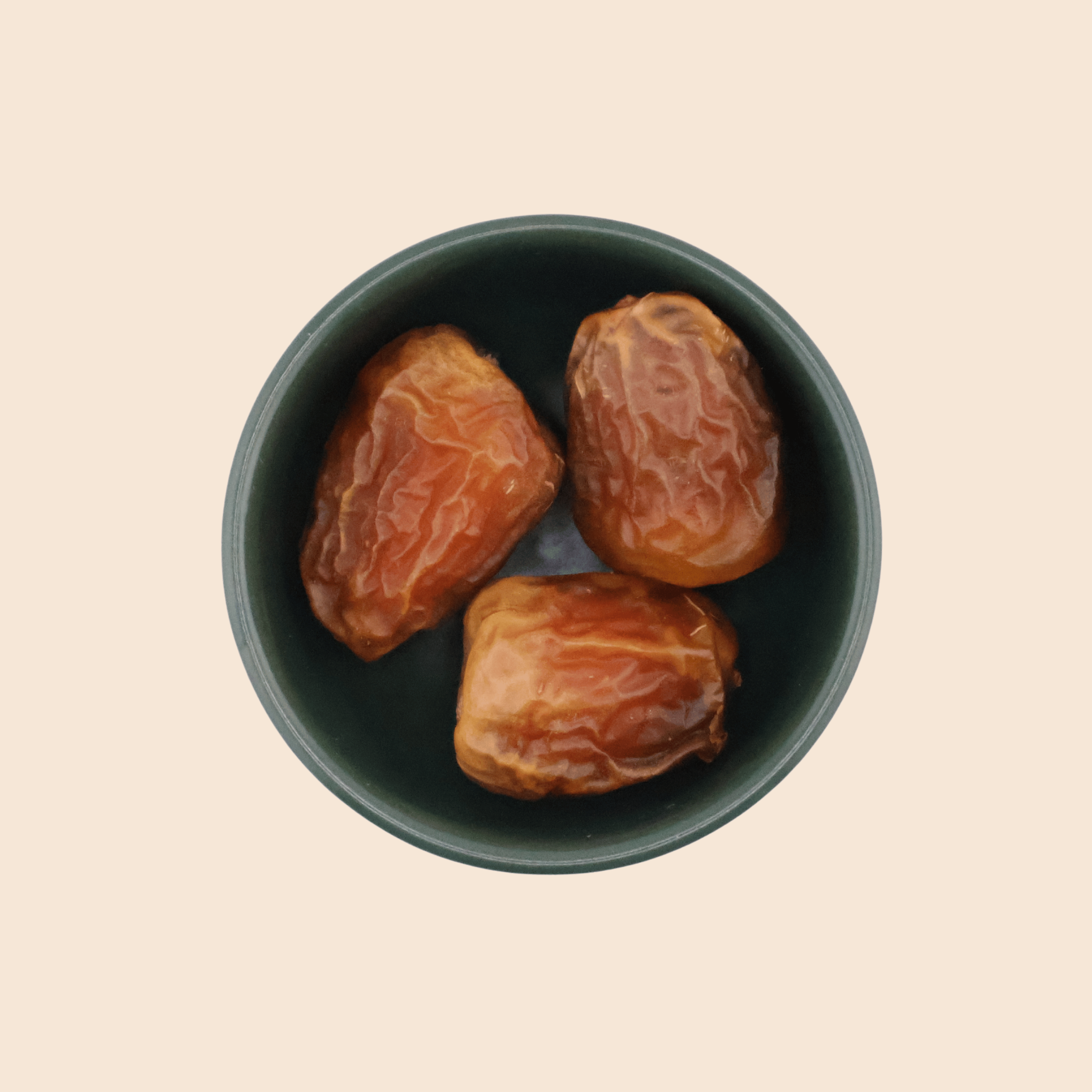 Top view of Sukkari Galaxy dates in a bowl, showing soft texture and rich caramel-coloured skin