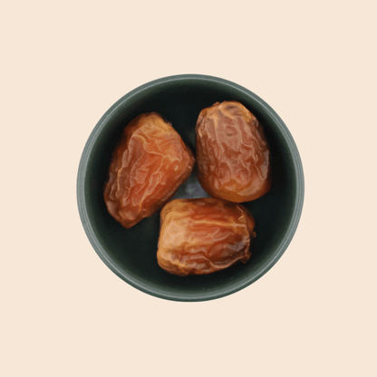 Top view of Sukkari Galaxy dates in a bowl, showing soft texture and rich caramel-coloured skin